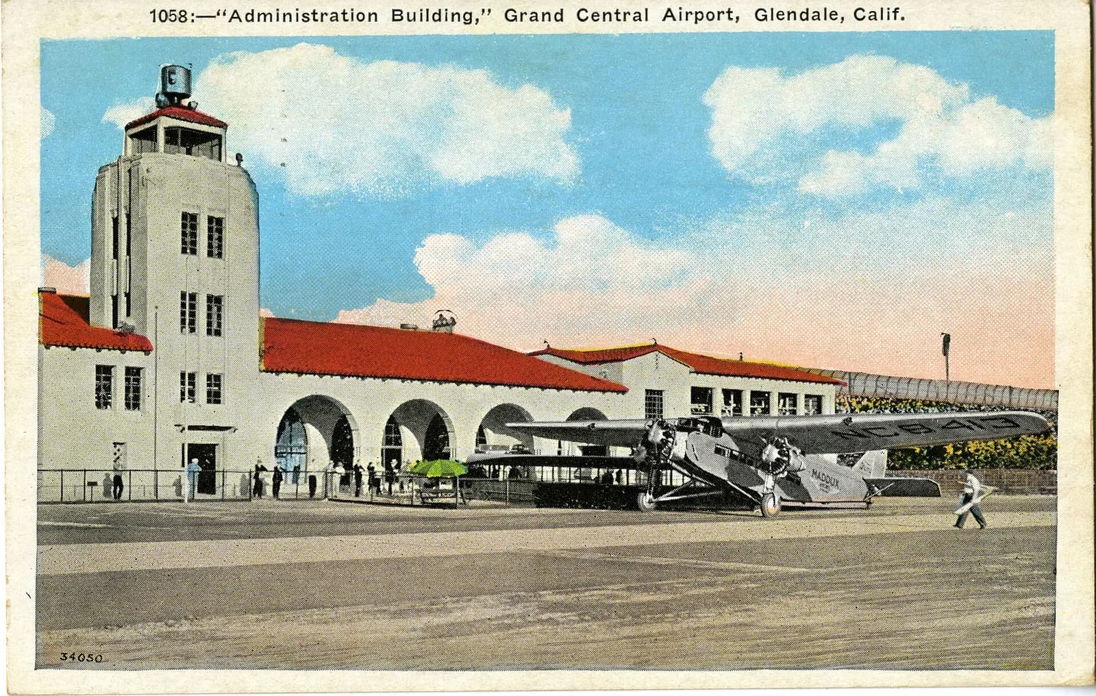 Exterior view of the Administration Building at the Grand Central Airport in Glendale . A Ford 5-AT-C Tri-Motor of Maddux Air Lines , registered NC-8413, is in front of the building. Historical Background : The City of Glendale, situated at the eastern end of the San Fernando Valley and bisected by 