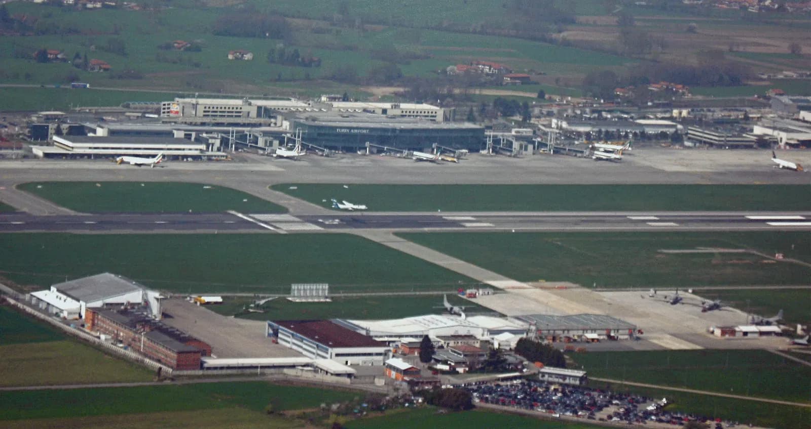 Aerial view of Turin Caselle Airport runway and terminal