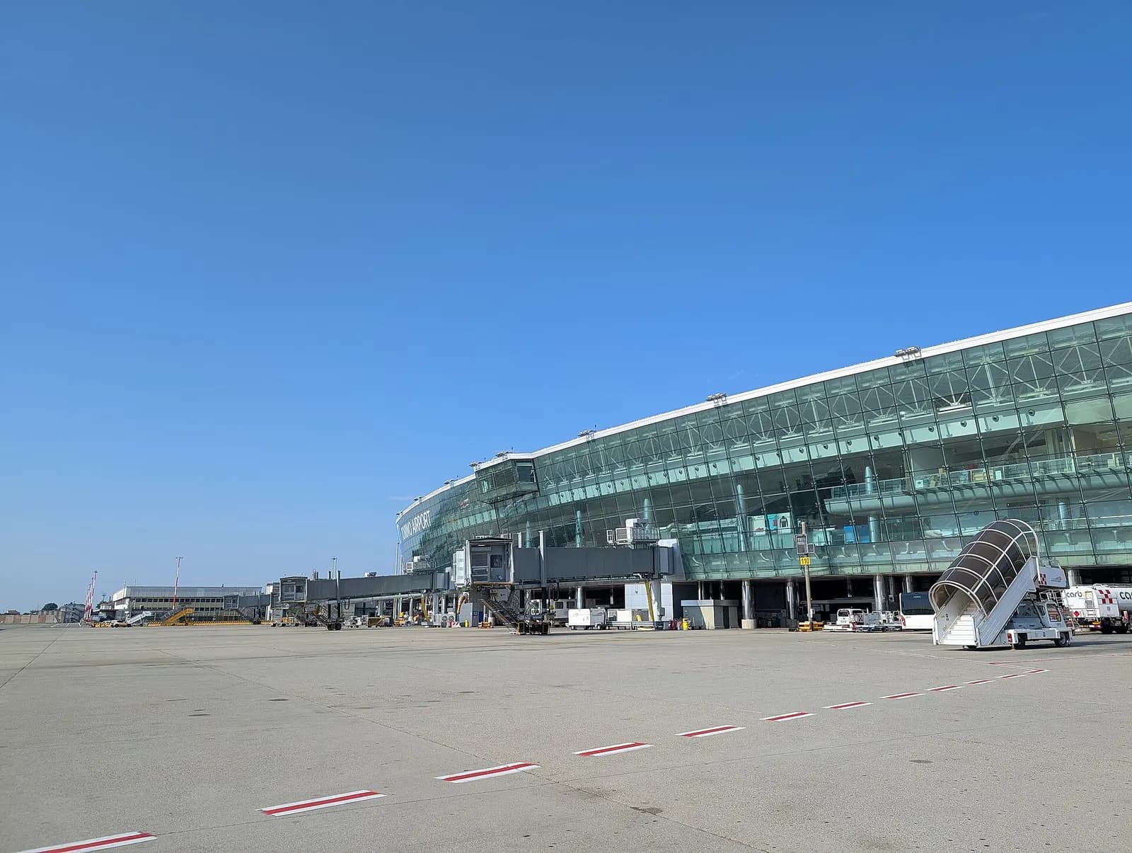 Turin Airport terminal seen across the apron from the runway side