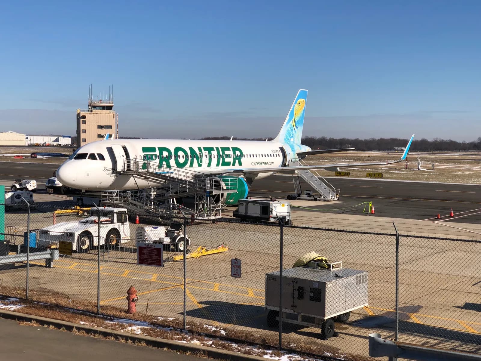 Frontier jet on the Trenton-Mercer ramp with passengers preparing to board outdoors in December 2024.