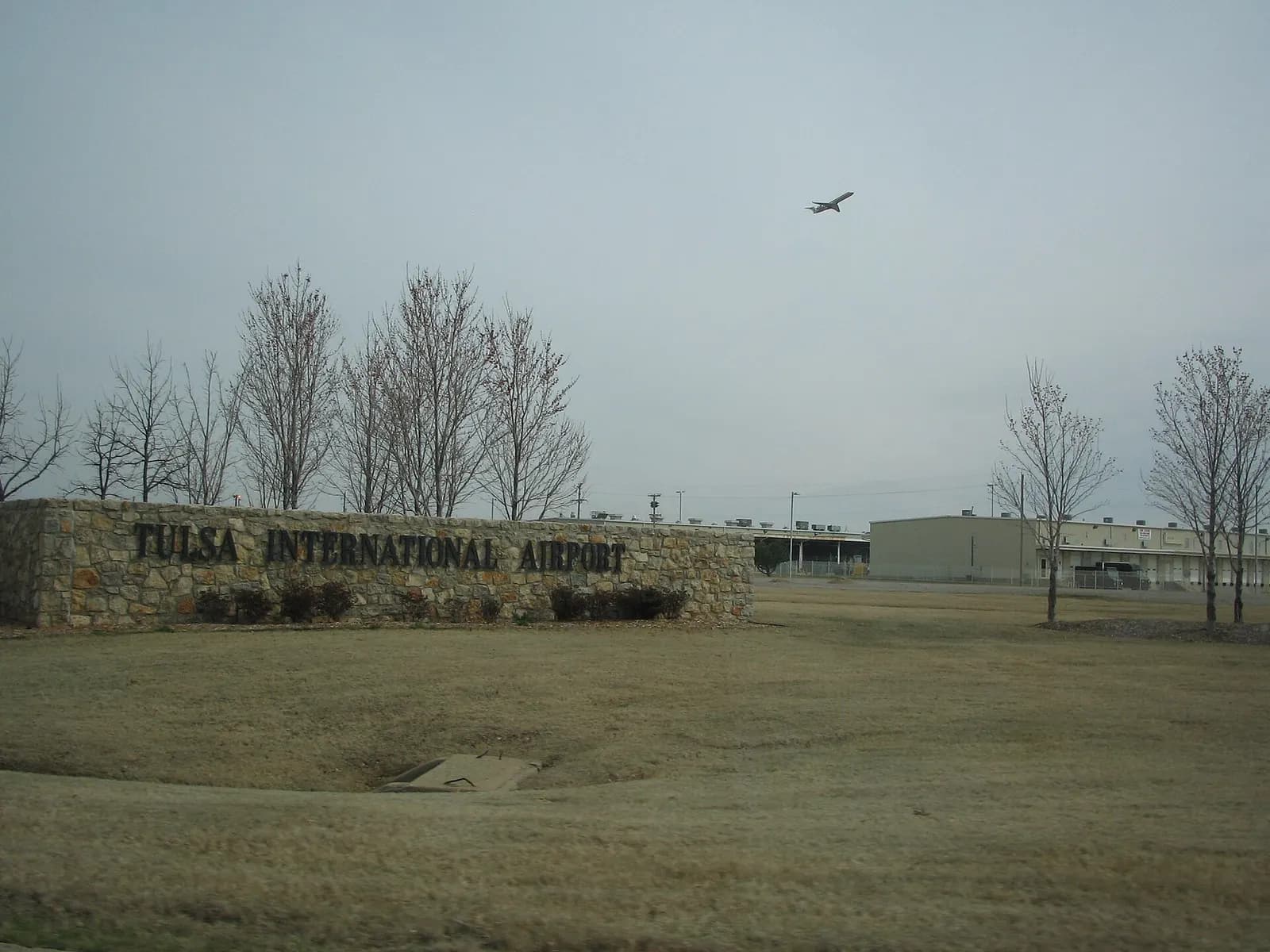 Roadway approach and entrance signage at Tulsa International Airport.