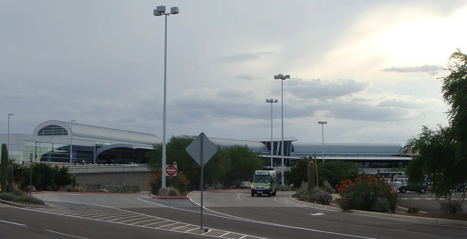 Landside view of Tucson International Airport's X-shaped passenger terminal from the curb