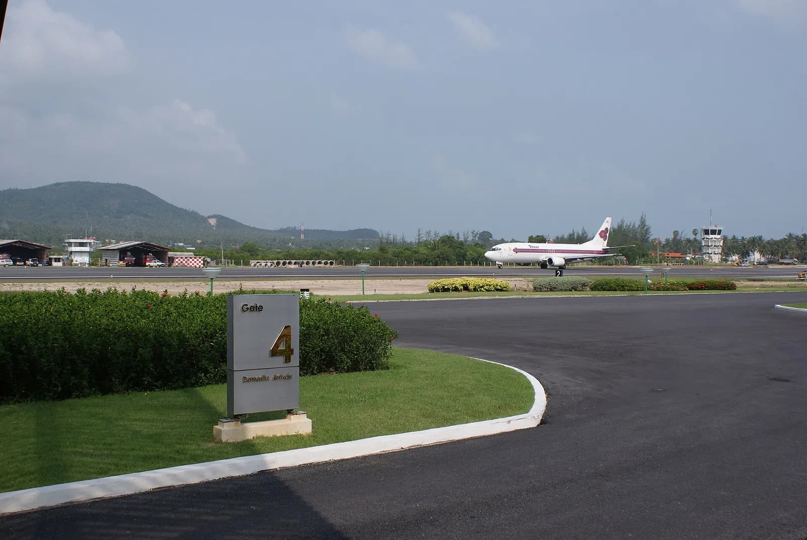 Samui Airport runway looking along the asphalt strip with tropical surroundings