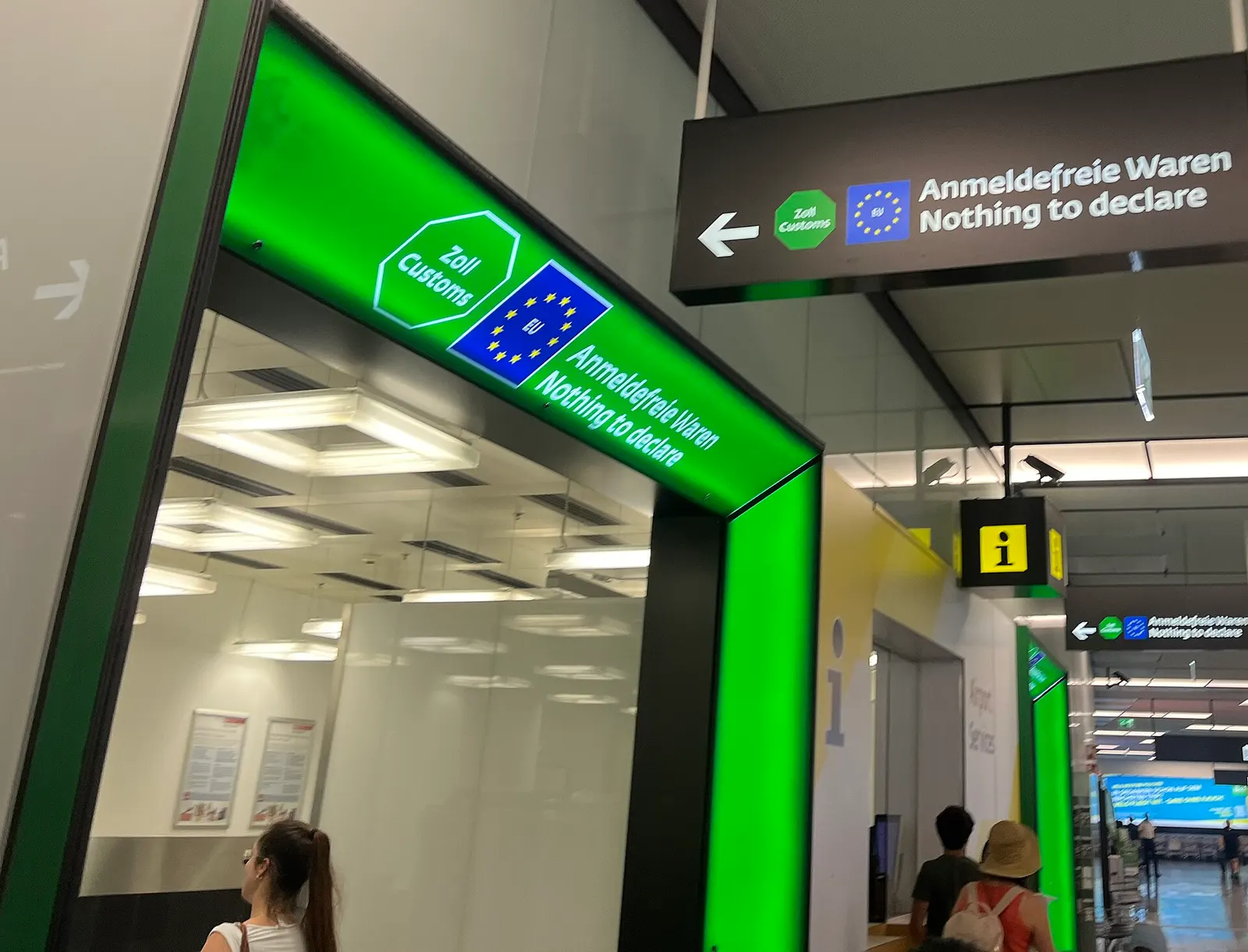 A customs area with a clearly marked green channel lane and signage directing passengers who have nothing to declare.