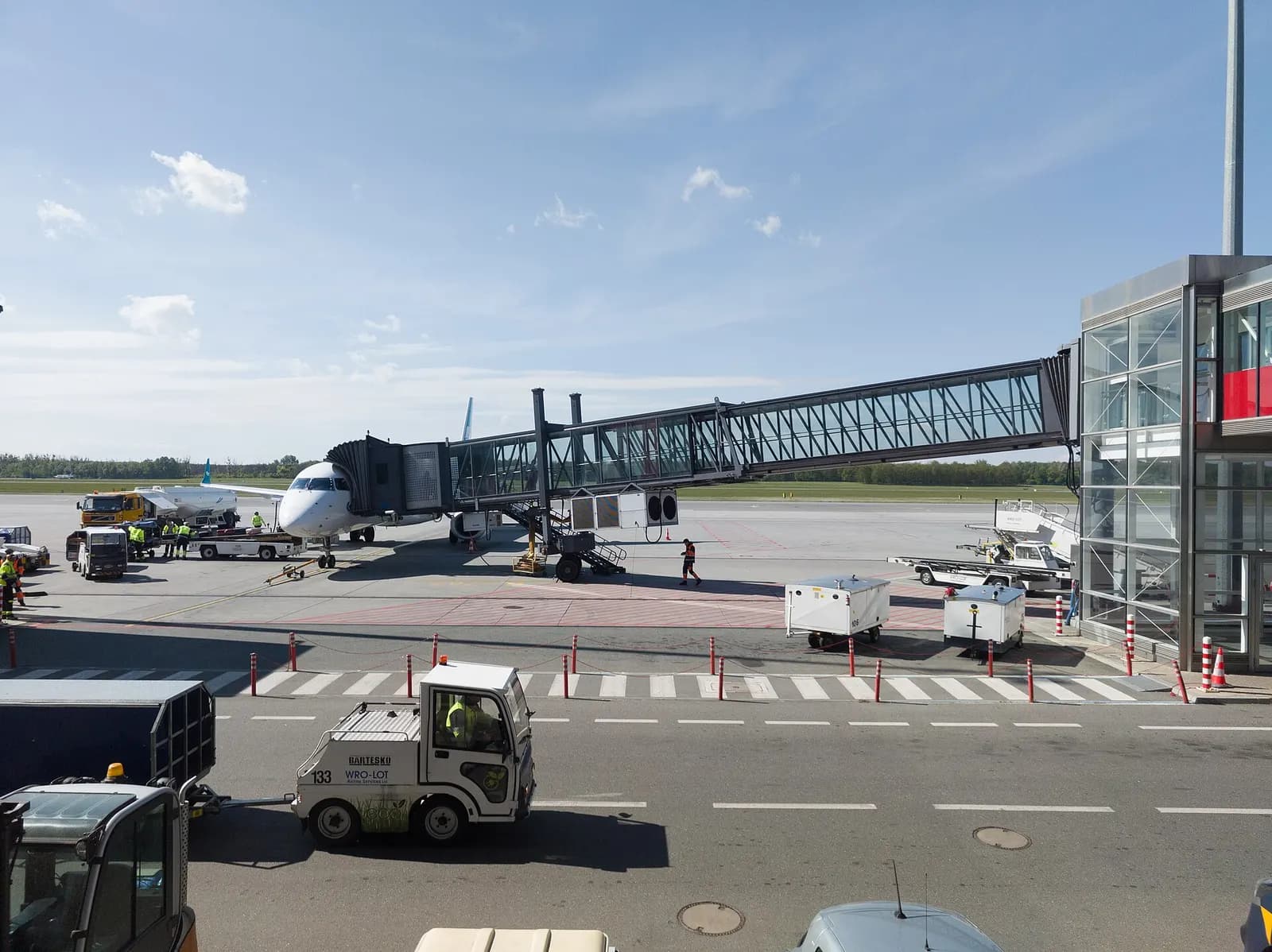 Landside view of Wrocław Airport terminal and forecourt in April 2024.