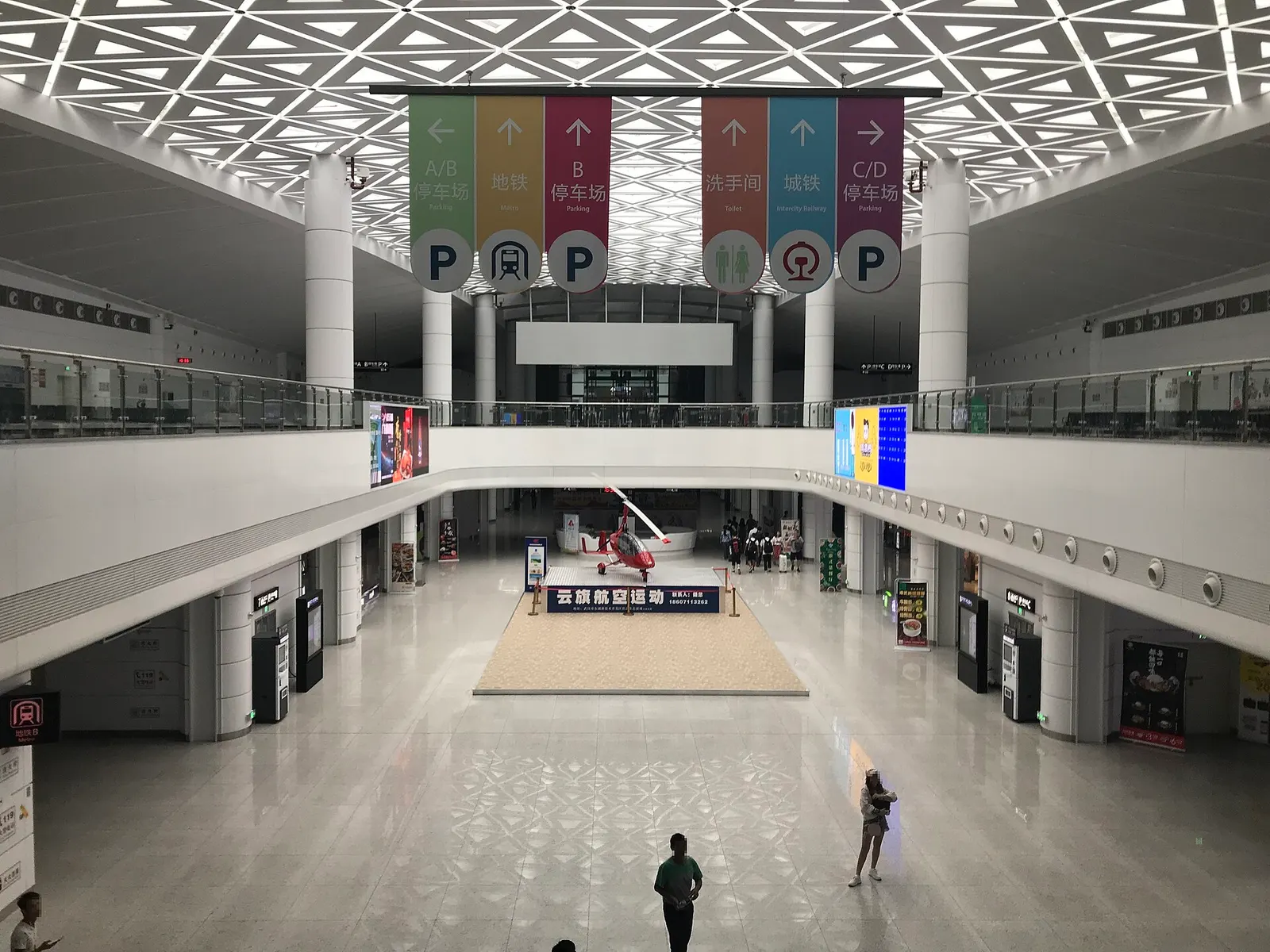 The interior of the Tianhe International Airport Traffic Center, a multi-level ground-transport hub with bus bays and pedestrian walkways.