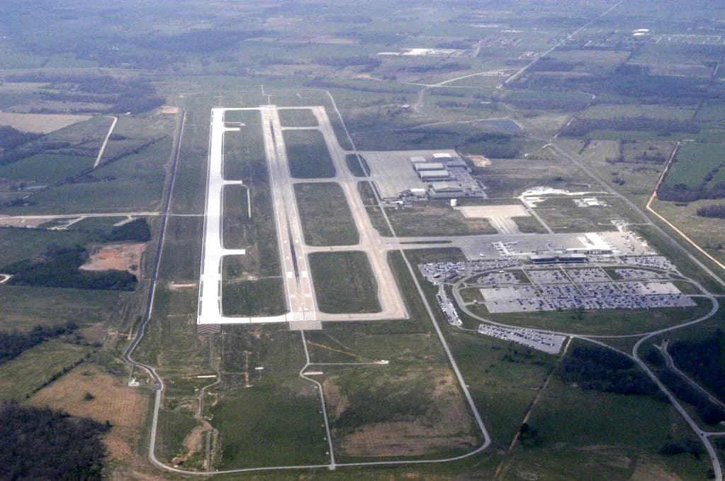 Civil Air Patrol aerial of XNA showing a single runway, the terminal and surface parking to the east, and farmland around Highfill.