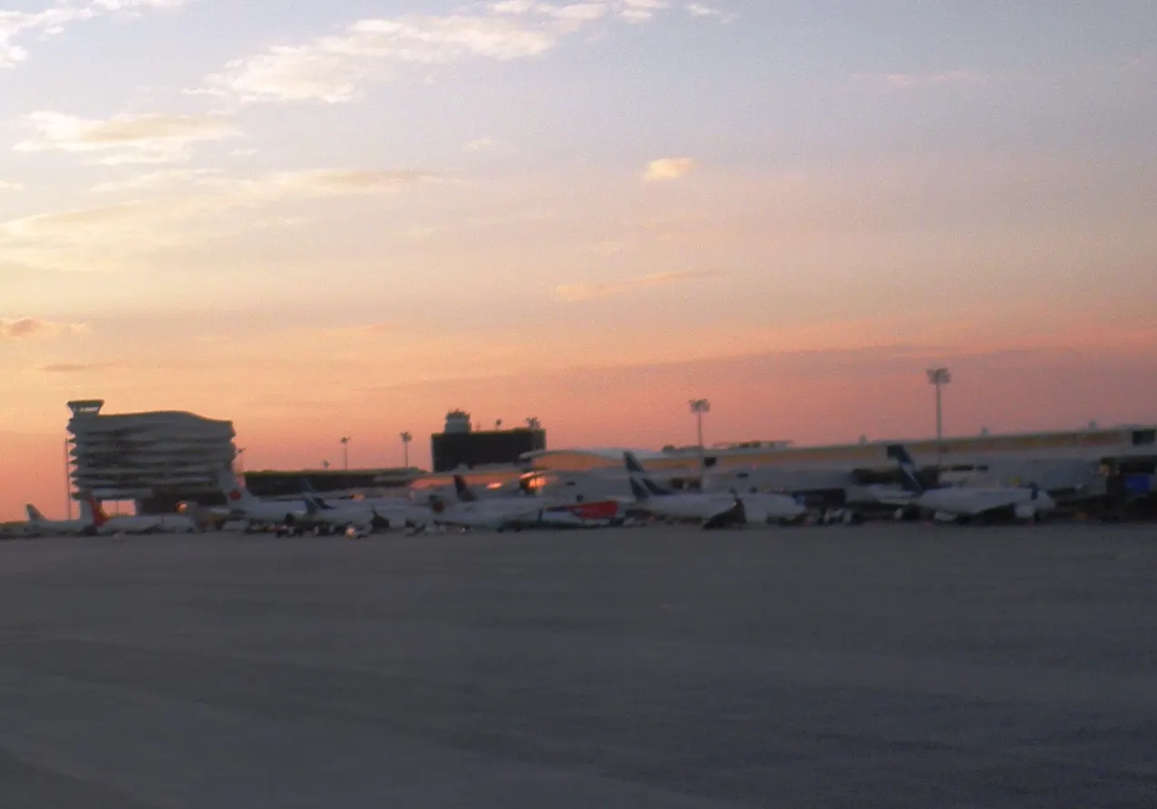 Sunset airside view of Edmonton International Airport with the ribbon control tower and WestJet aircraft