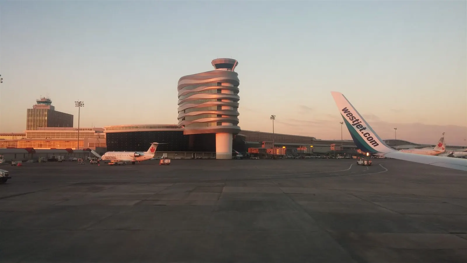 YEG control tower from a WestJet window, with an Air Canada Express Dash 8 on the apron
