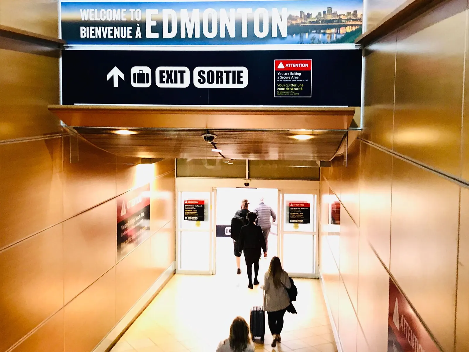 Bilingual Welcome to Edmonton arrival corridor and Exit / Sortie doors at Edmonton International Airport
