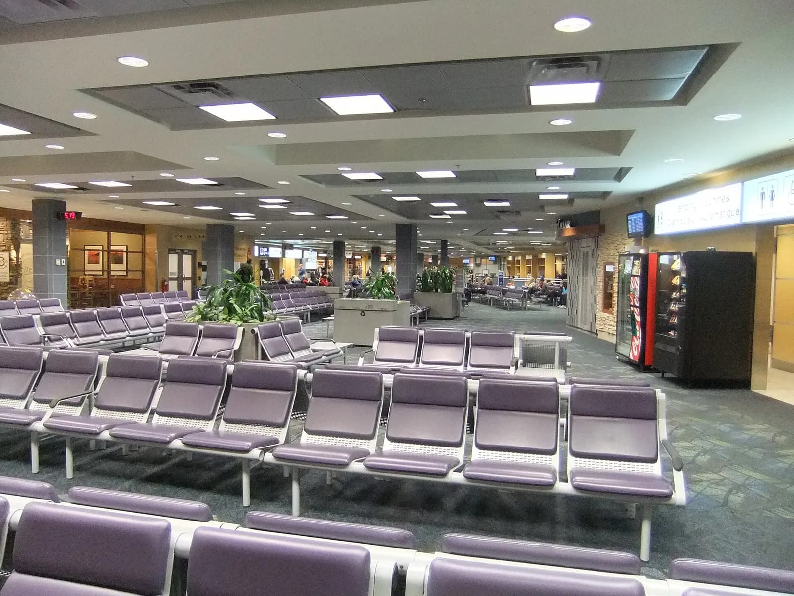 Historic 2013 Kelowna International Airport departure holdroom with seating and windows looking onto the apron.