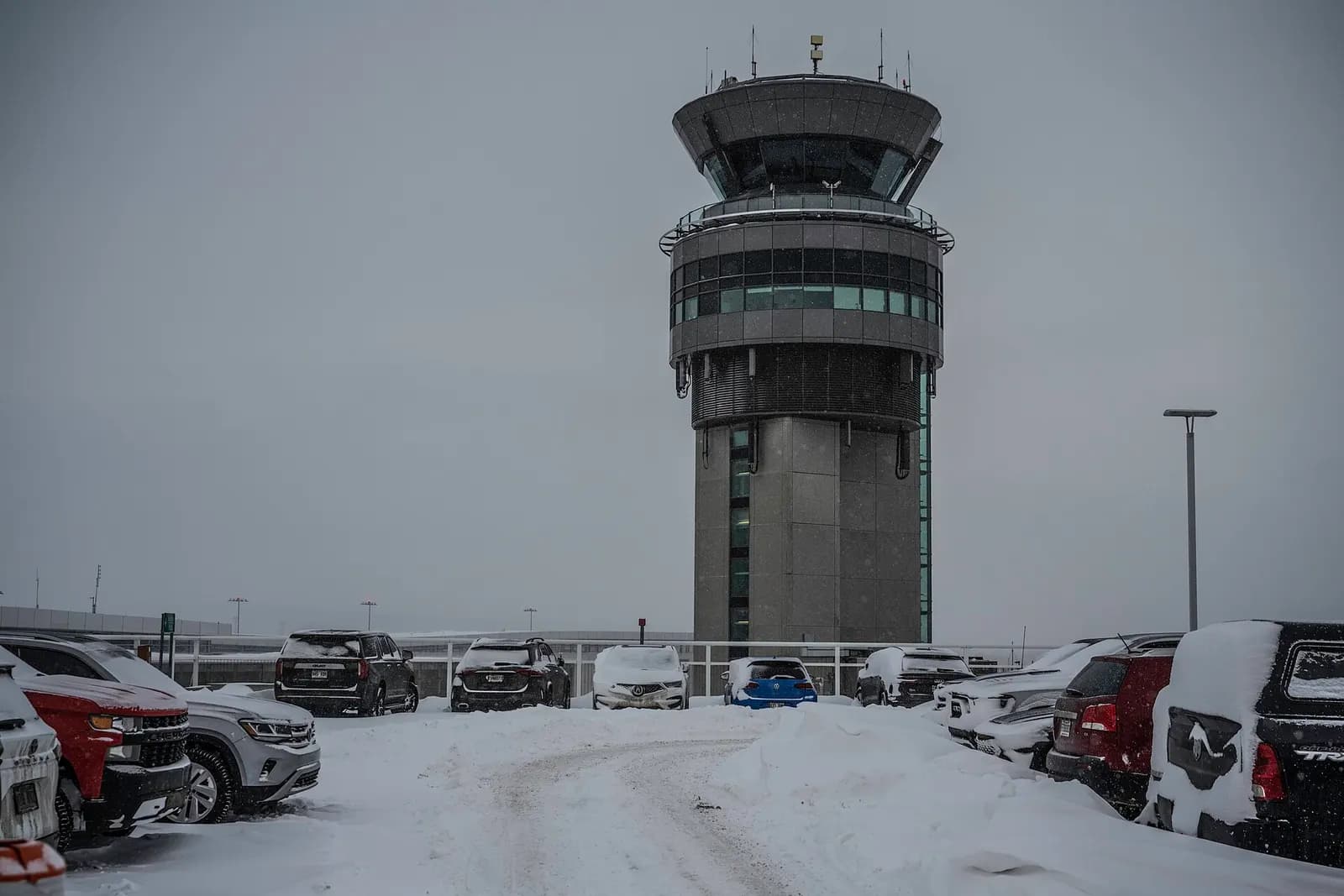 YQB control tower and snow-covered terminal parking in winter