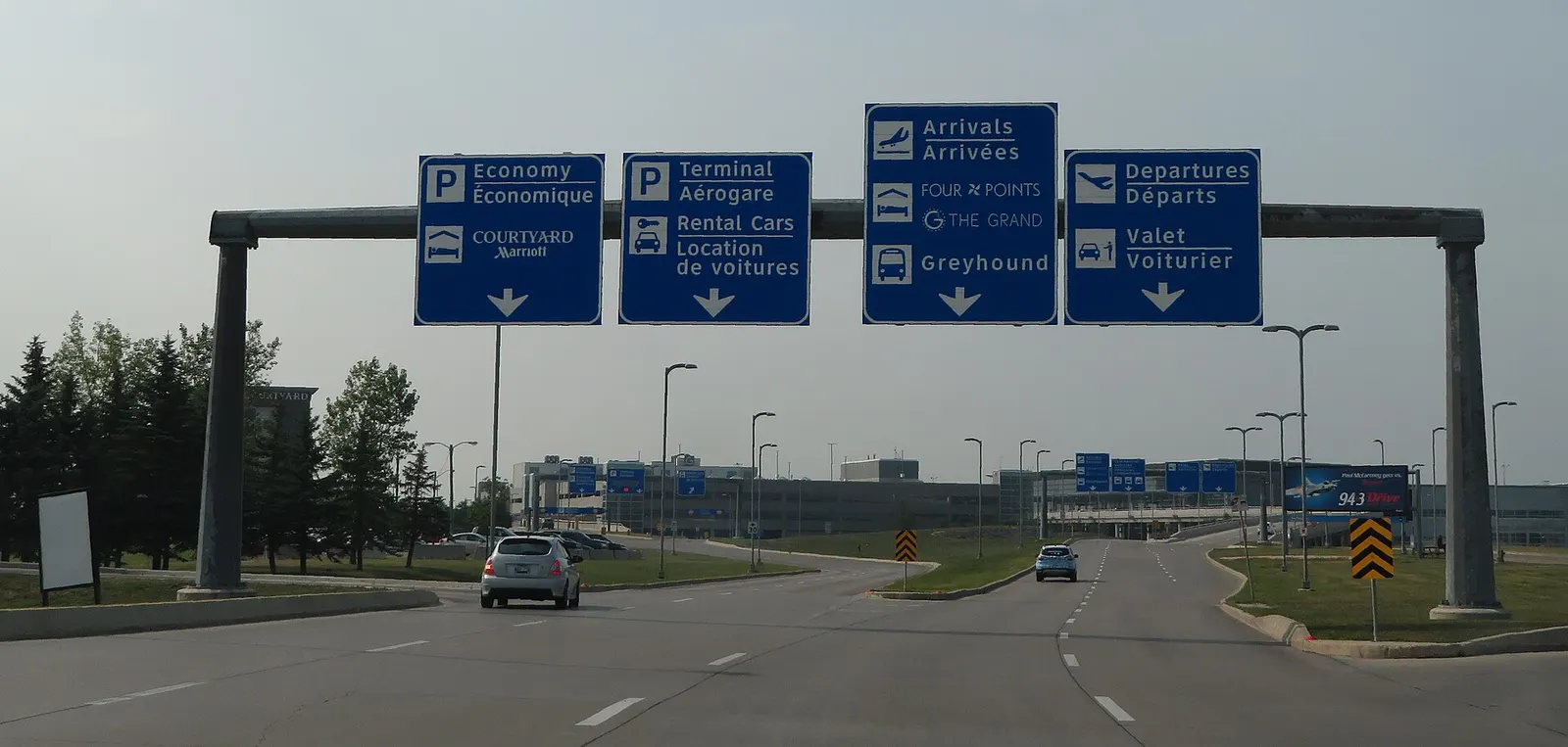 Bilingual approach gantry for Economy, Terminal, Arrivals, and Departures at YWG