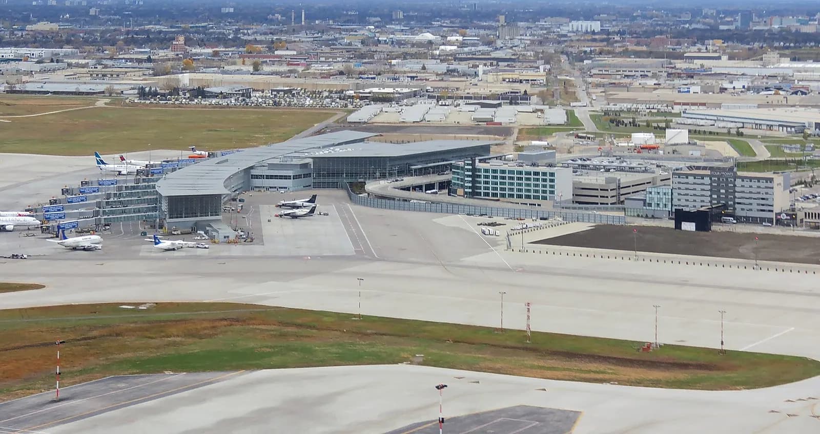 Apron and main terminal at Winnipeg Richardson with WestJet, Air Canada, and Bearskin metal