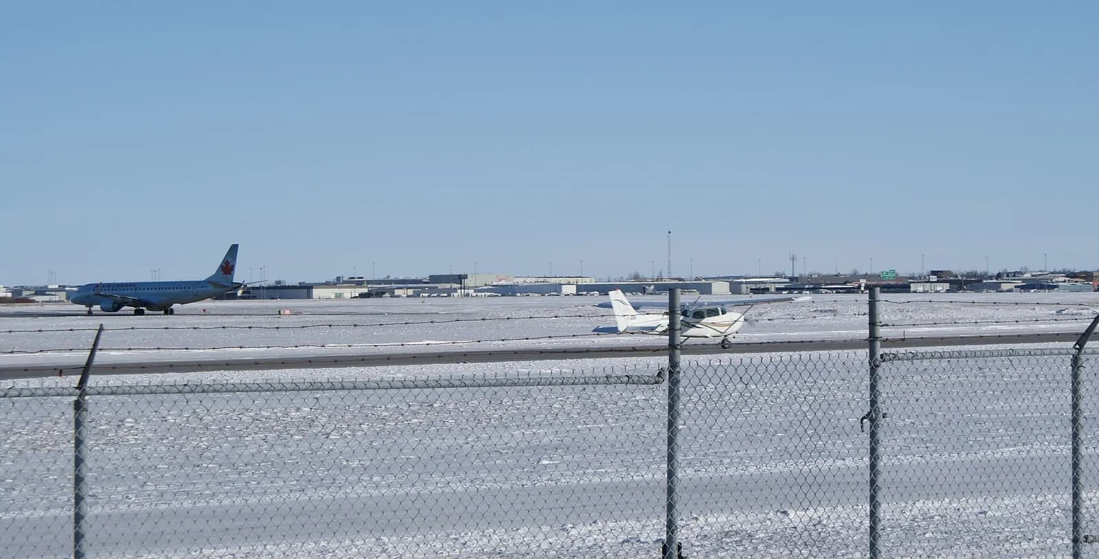 Snow-lined runway and taxiway view at Saskatoon John G. Diefenbaker International Airport in January 2009.