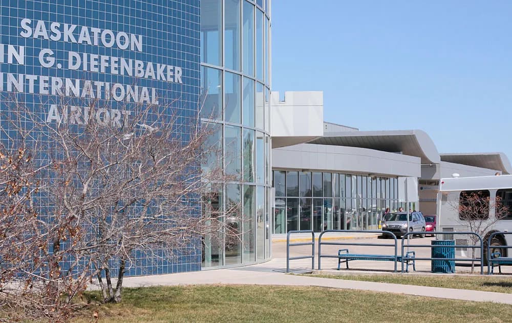 Daytime exterior of the Saskatoon airport terminal and aircraft parking apron photographed in April 2010.