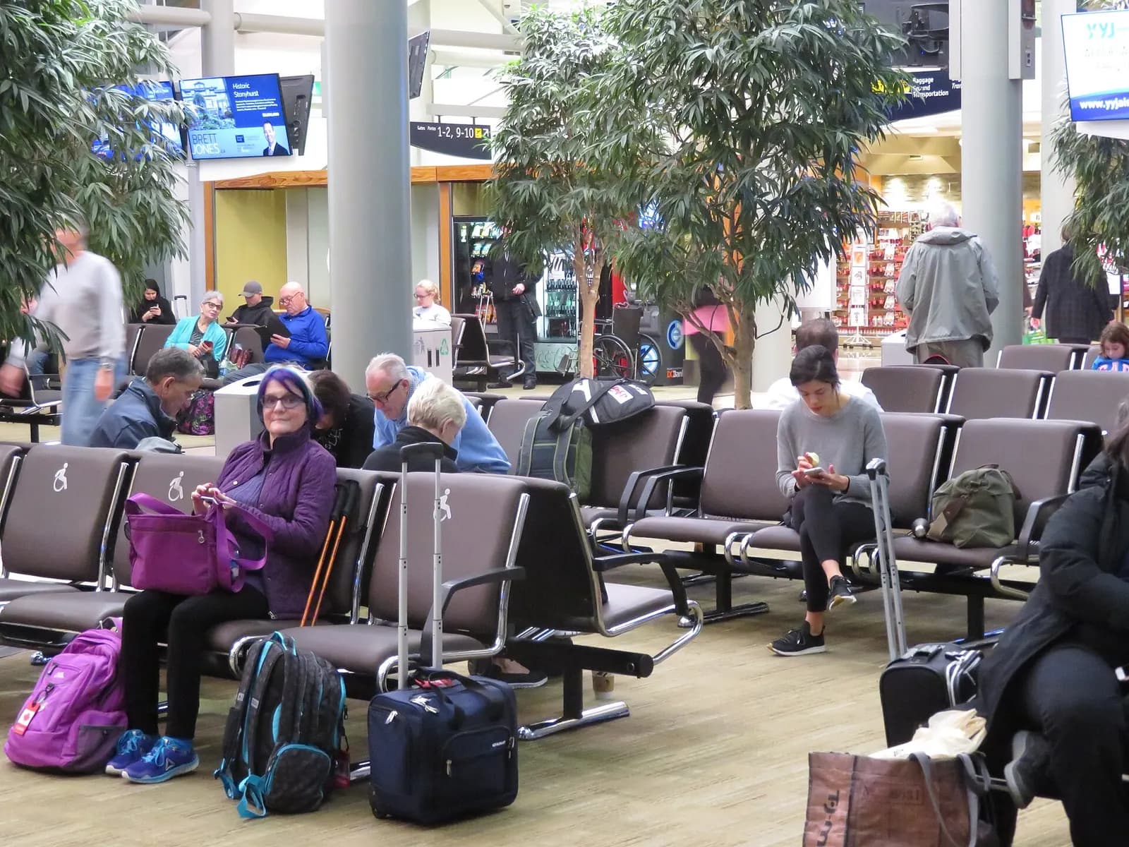 Airside holdroom seating at Victoria International Airport with large windows looking onto the apron.