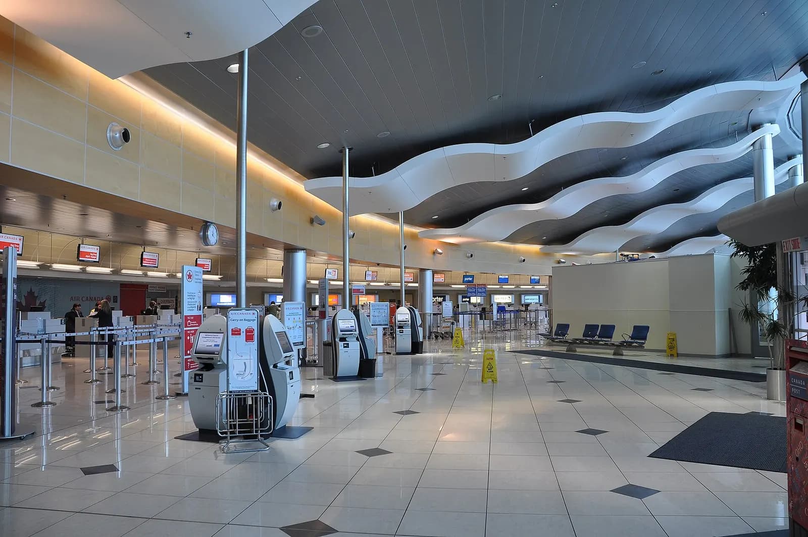 Check-in hall at St. John's International Airport with airline counters and overhead signage, June 2015.