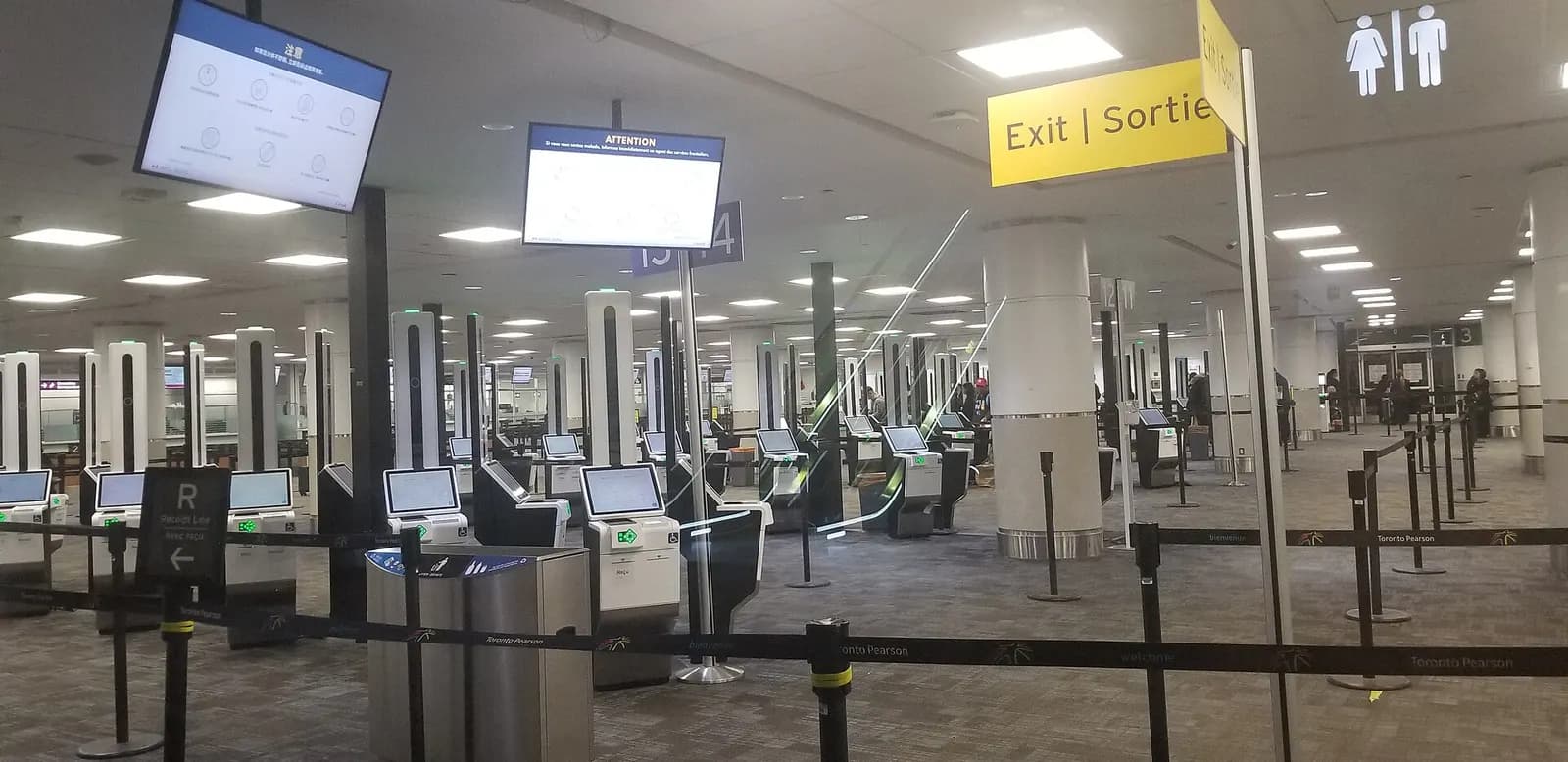 A row of automated primary inspection kiosks lines the customs and immigration area in Terminal 3 international arrivals.